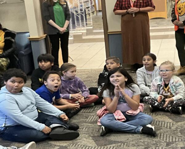 Longfellow New Tech fourth-grade students react with excitement and joy while listening to Griffith Calumet Township Librarian Janet Gibson.